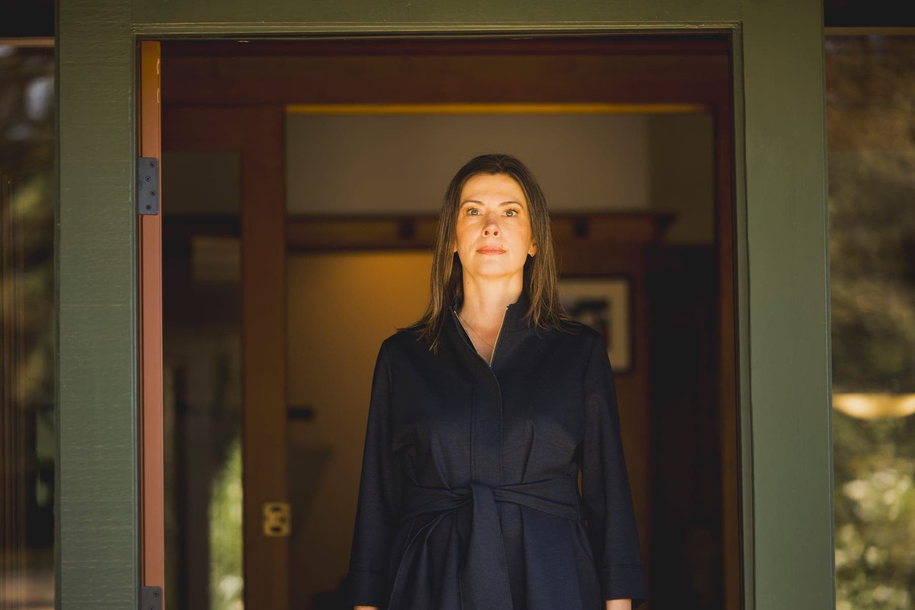 Kathleen Defever standing in a sunlit doorway